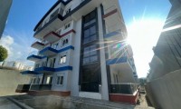 Новая двухкомнатная квартира в современном комплексе в районе Махмутлар